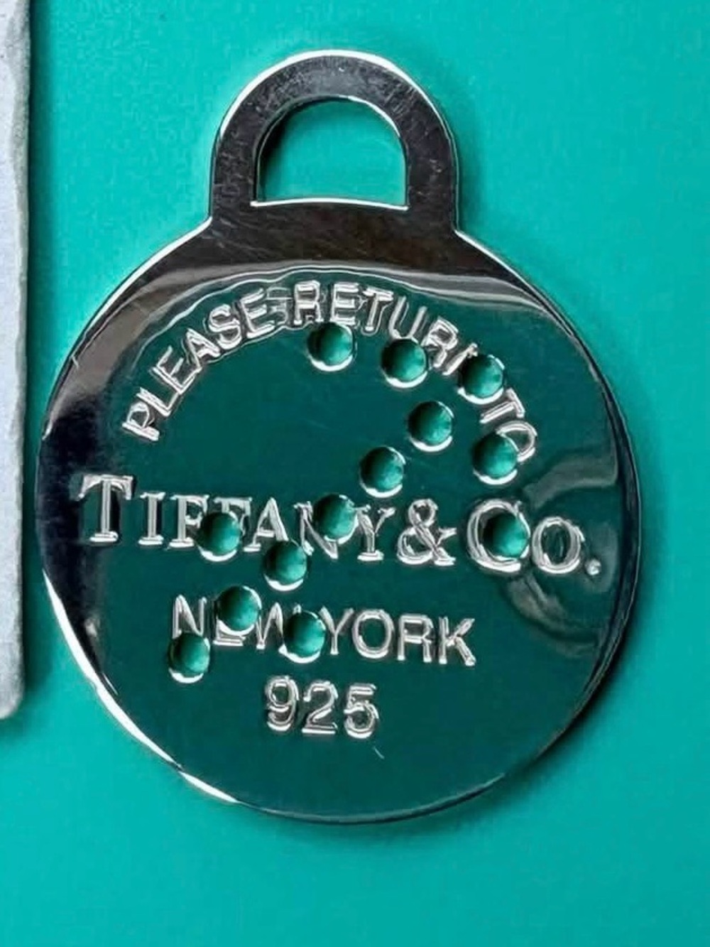Tiffany & Co. Silver Round Return-to Tag on Tiffany Blue